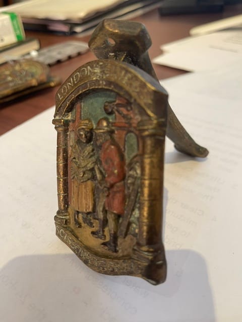 Cast metal decorative door knocker or furniture mount with figural relief