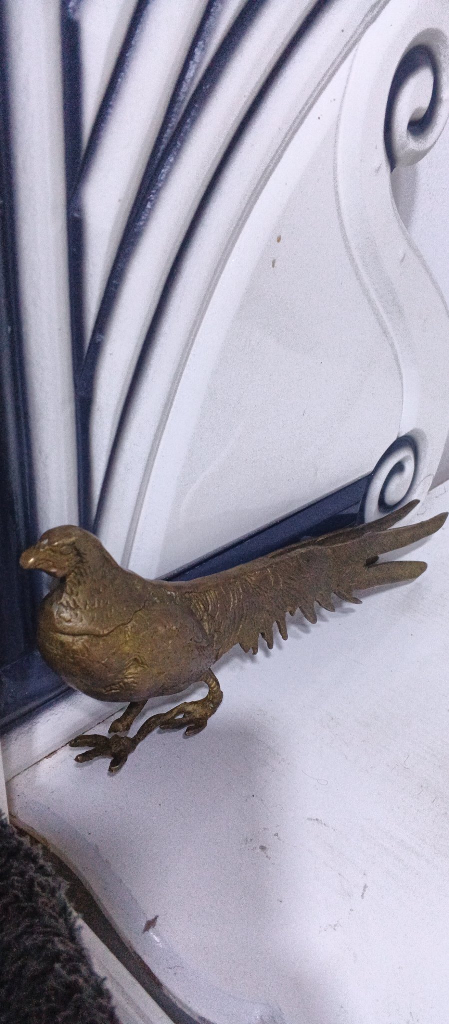 Decorative metal bird figurine (likely pheasant or rooster)