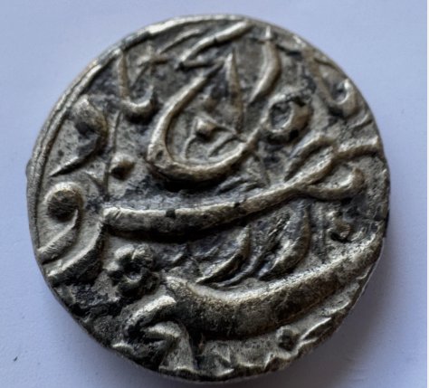 Decorative metal button or medallion with raised scrollwork
