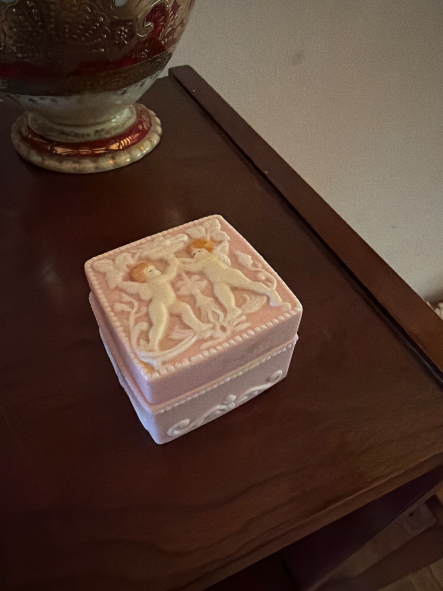 Decorative porcelain trinket box with cherub relief