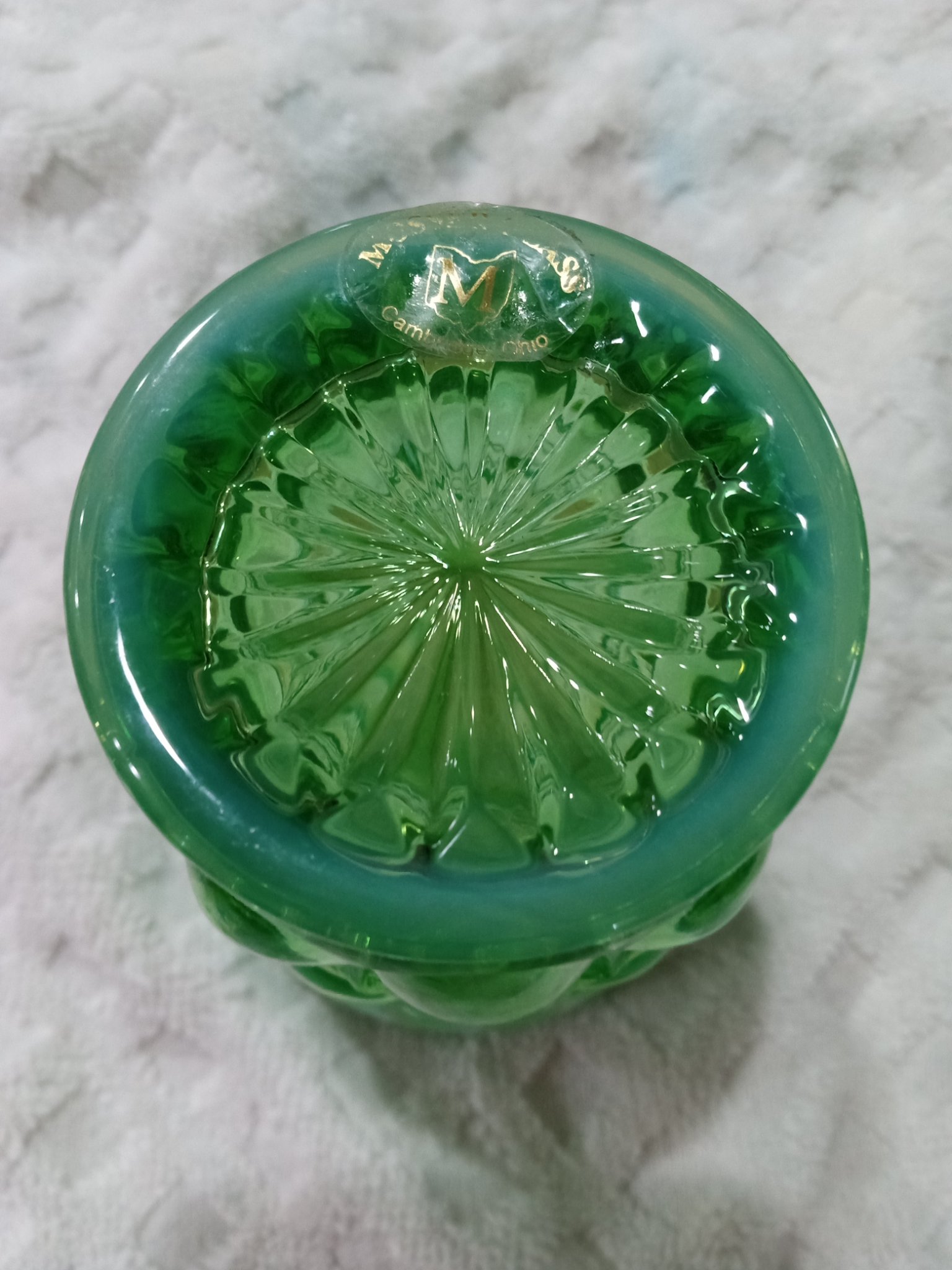 Green pressed-glass decorative bottle or perfume bottle with applied label