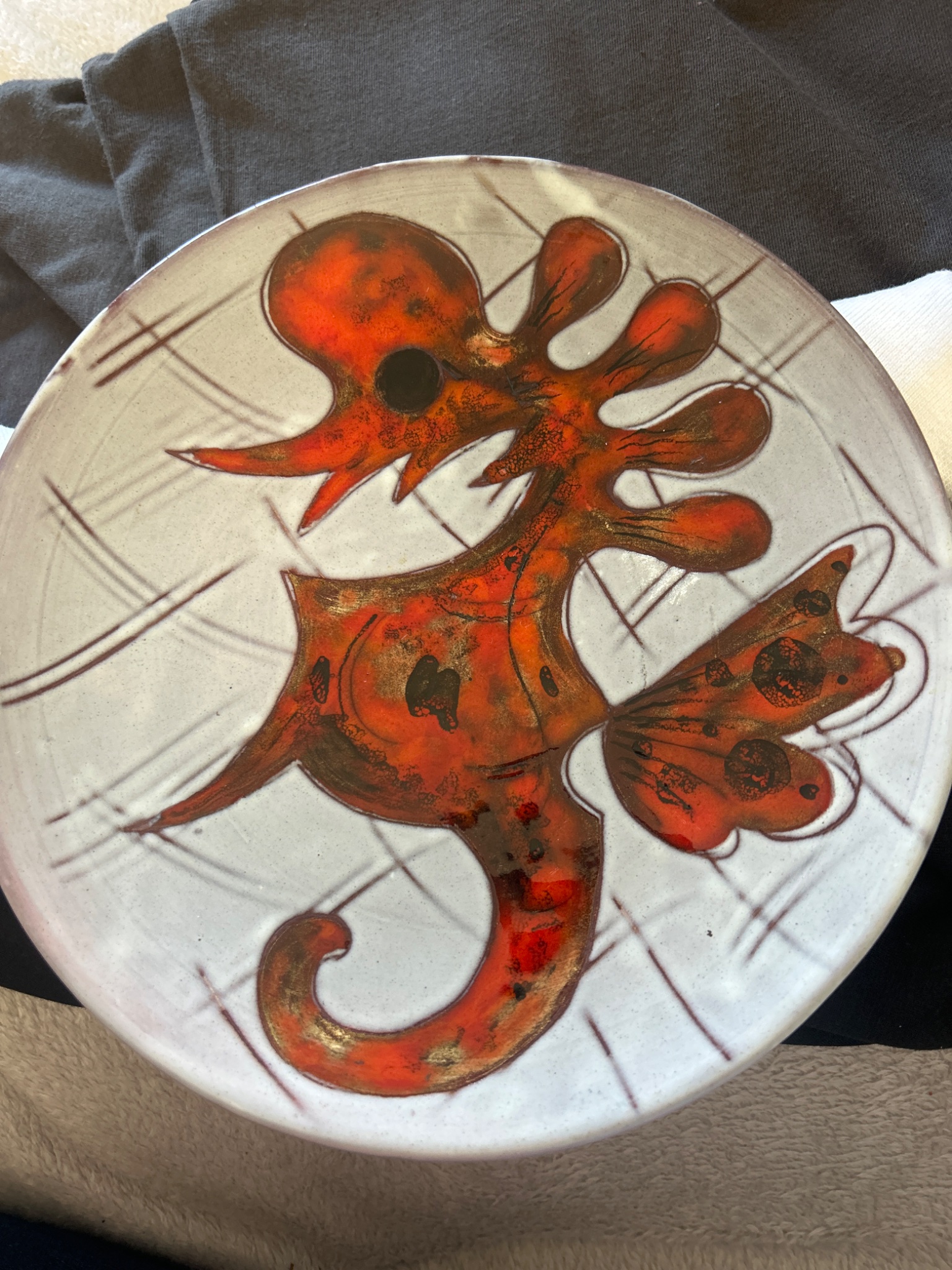 Hand-painted decorative ceramic plate or charger with abstract fish/octopus motif