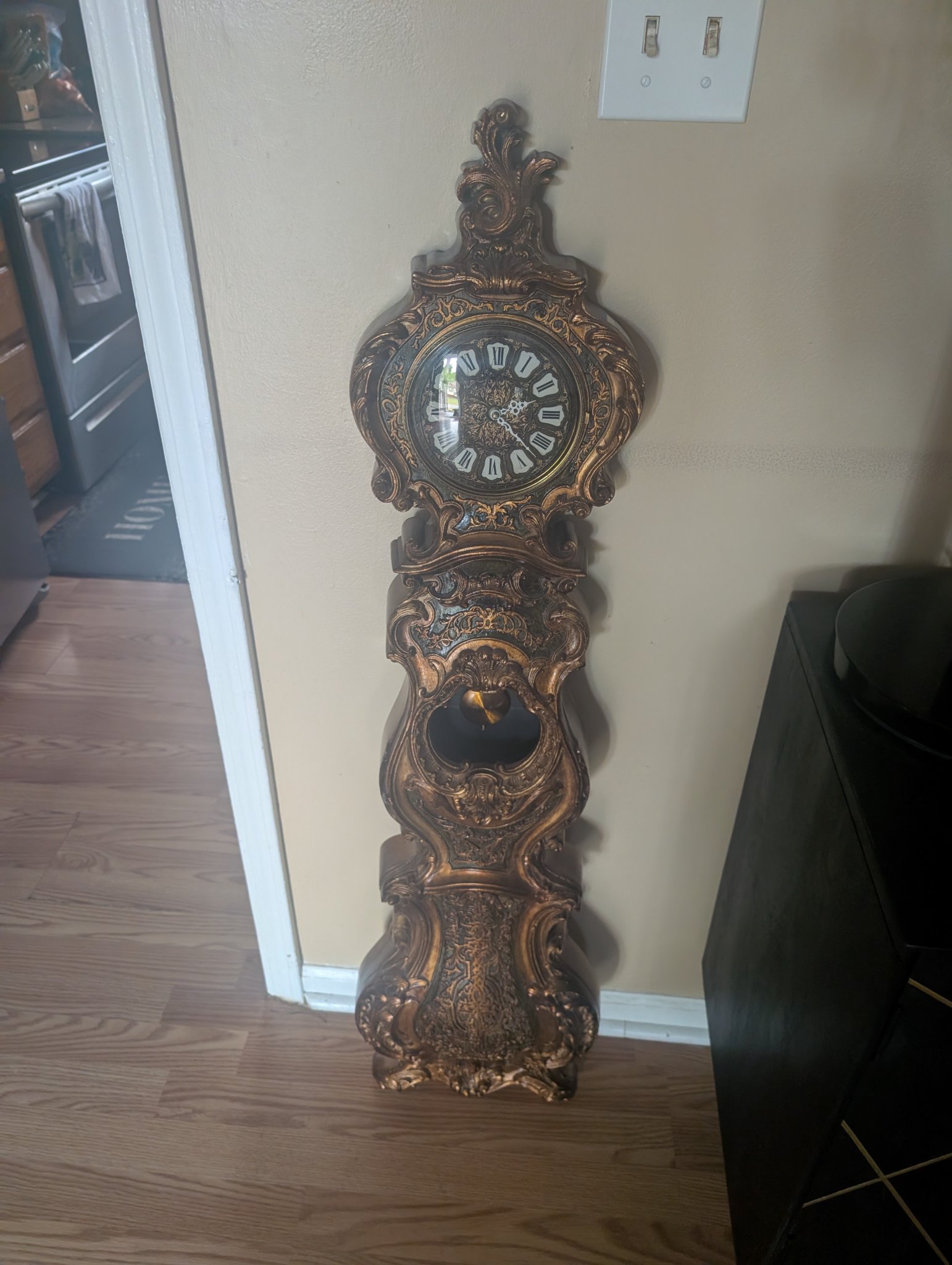 Ornate wall-mounted pendulum clock