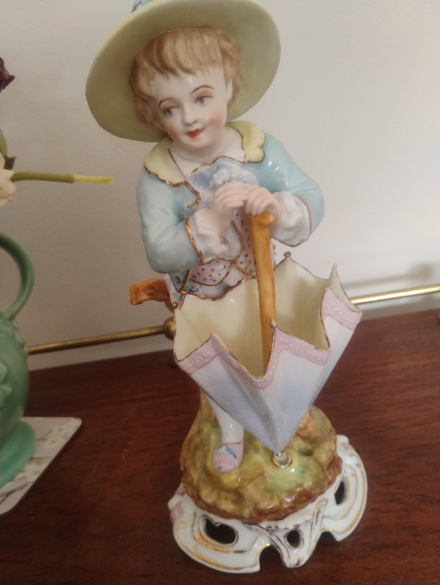 Porcelain figurine of a young girl with umbrella