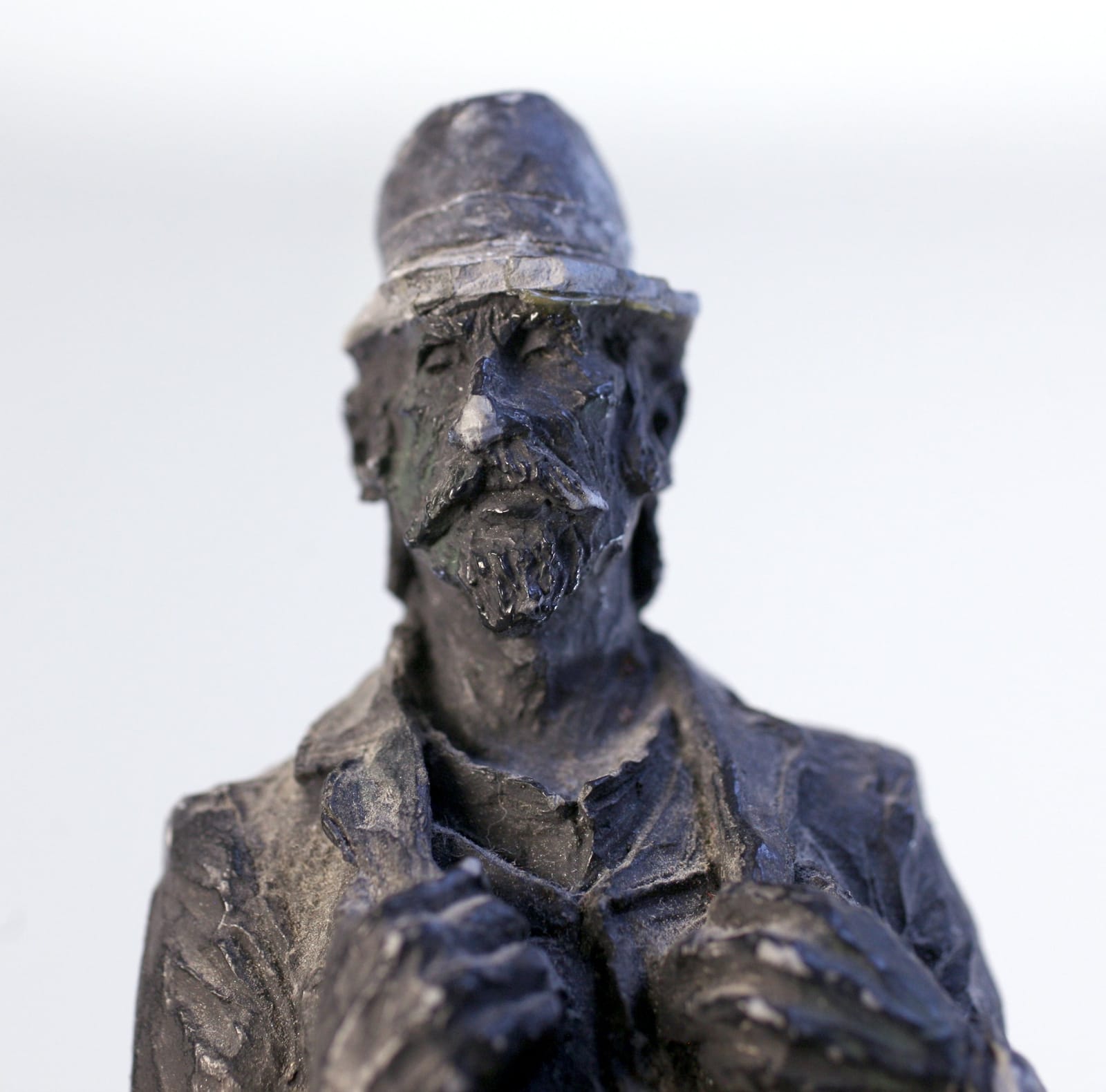 Small carved figurative sculpture of a bearded man