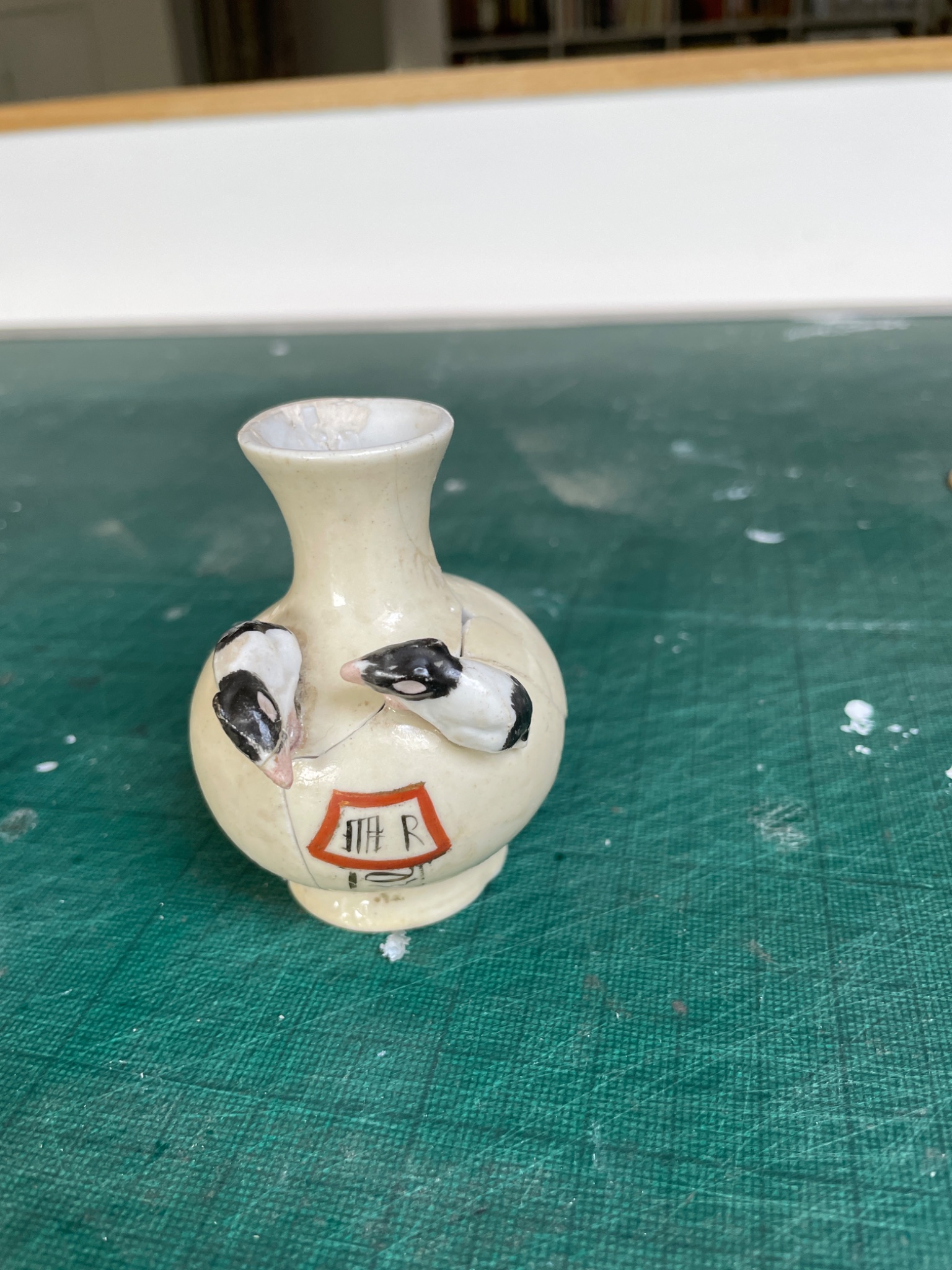 Small porcelain miniature vase with applied bird decoration