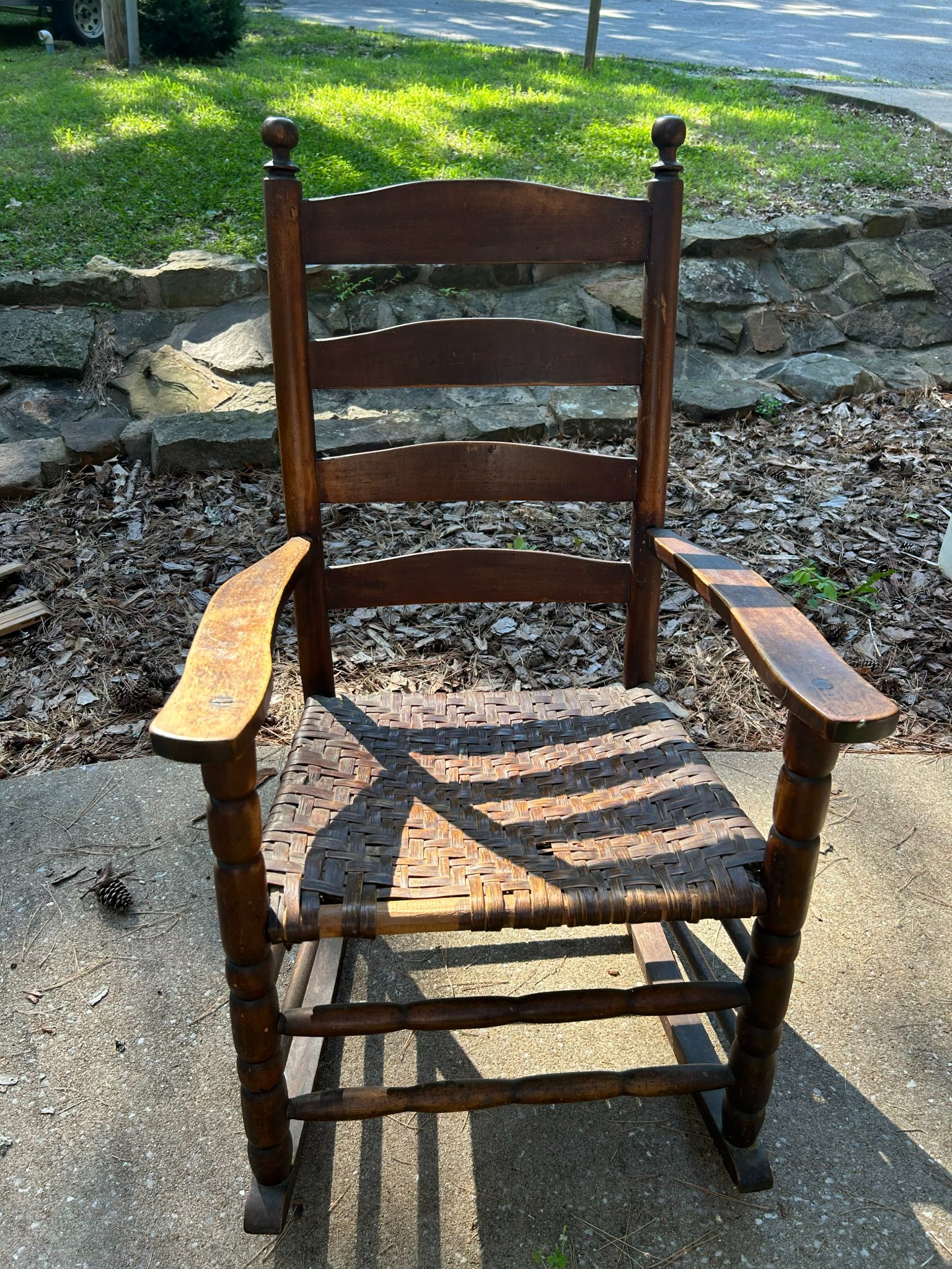 Windsor-style ladder-back rocking chair with woven seat
